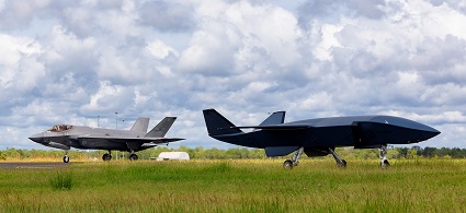 An MQ-28A Ghost Bat on the tarmac as an F-35A Lightning II taxis after a sortie during Exercise Carlsbad at RAAF Base Tindal.