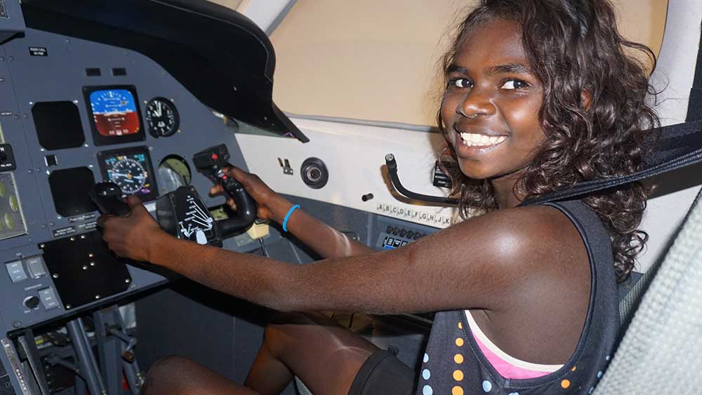 Young student in a flight simulator.
