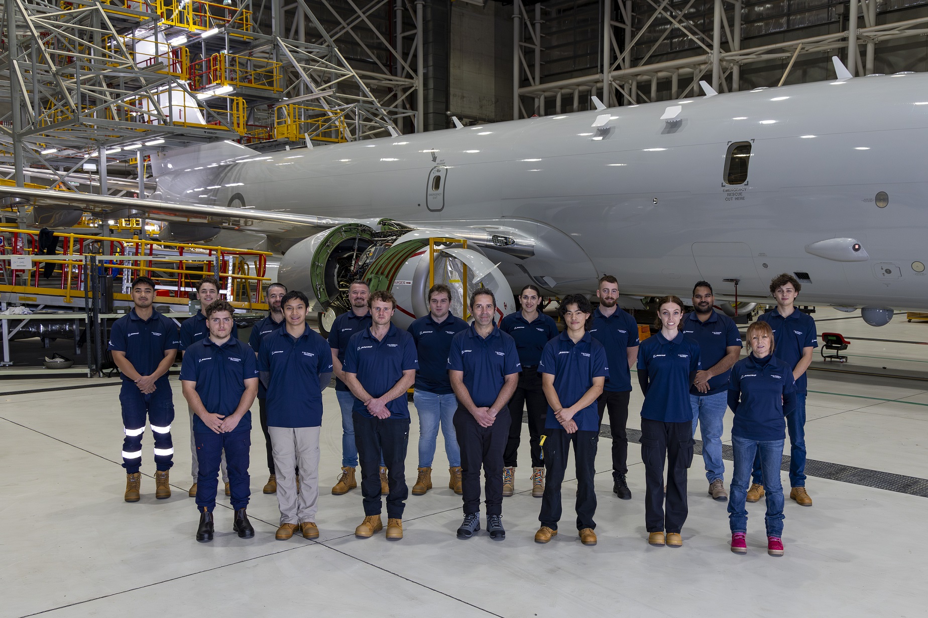 Boeing trainees in front of P-8A Poseidon aircraft